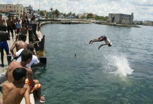Most of those diving off the Malecon seawall are young men and boys. - Jorge Luis Banos/IPS