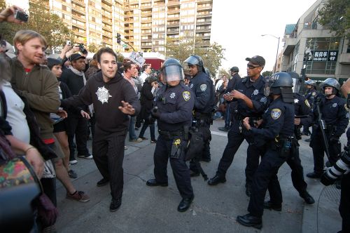 A member of Occupy Oakland attempts to defuse a confrontation with police at the Nov. 2 at the General Strike. - John Jernegan/IPS