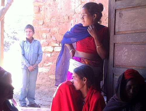 Battered Nepali women catch a moment together.  - Naresh Newar/IPS