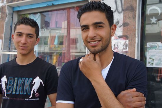 Abdullah Aldiamy (right) outside his family shop at Omar Zerti's occupied building. - Rebecca Murray/IPS.