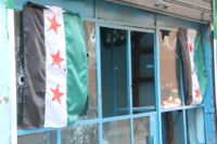 A shop window in Tripoli in Lebanon marked by bullet holes after sectarian fighting over the Syrian revolution.  - Zak Brophy/IPS.