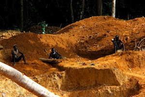 In the forest in Gbarpolu County, northwest Liberia, a group of men work on a surface gold mine unaware of the environmental impact their work has. - Travis Lupick