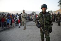 Brazilian peacekeepers and U.S. soldiers distribute food and water in Haiti's capital.  / Credit:UN Photo/Sophia Paris