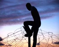 Man atop the
Israeli security fence at Budrus. / Credit:Still image from
"Budrus"