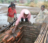 Repairing a latrine in Mgona township, Lilongwe. / Credit: Claire Ngozo/IPS