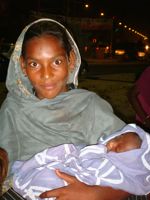 A health worker with her baby. - Zofeen Ebrahim/IPS.