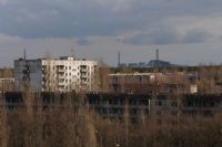 Abandoned houses close to the Chernobyl plant behind. - Alina Rudya