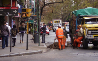Woman being harassed by a crew of workers on a Buenos Aires street.  - Juan Moseinco/IPS 