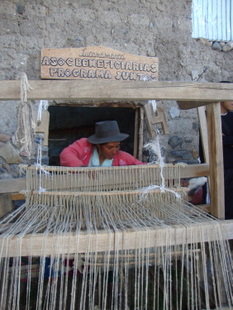 Vilma Matias weaving on a loom at the Lucanamarca workshop. - Milagro Salazar/IPS