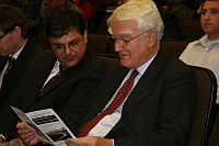 Sir Mark Moody-Stuart, chairman of Anglo American plc, reads a leaflet criticising his company prior to his presentation. / Credit:Chris Arsenault/IPS