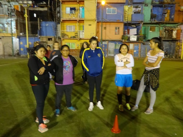 Girls from the La Nuestra football team wait to start their twice-weekly training in the Villa 31 shantytown in Buenos Aires. They often have to cut short their practice when boys take over the local pitch. Credit: Fabiana Frayssinet/IPS