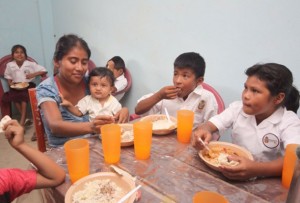 A mother eats lunch with her children in a rural Mexican school, as part of one of the programmes that fall under the umbrella of the Crusade Against Hunger. Credit: Government o Mexico