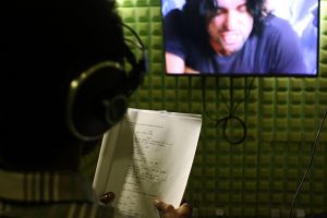 One of KANA TV’s dubbing team in a specially equipped sound-proof studio reading from his Amharic script to dub over a Turkish actor. Credit: James Jeffrey/IPS