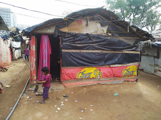 A child plays outside a makeshift home in a Rohingya camp, Jammu, India. Credit: Stella Paul/IPS