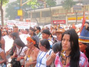 "We are fighting for the demarcation of our territory," reads a banner in a march of indigenous women who came to Rio de Janeiro from the communities of the 305 native peoples of Brazil, to demand respect for the rights recognised by the constitution, which far-right President Jair Bolsonaro began to ignore as soon as he was sworn in. Credit: Mario Osava/IPS
