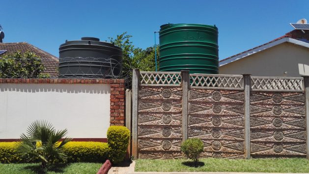 Water tanks installed in homes in a Bulawayo suburb. The city has been facing a decades long water crisis. Credit: Ignatius Banda/IPS
