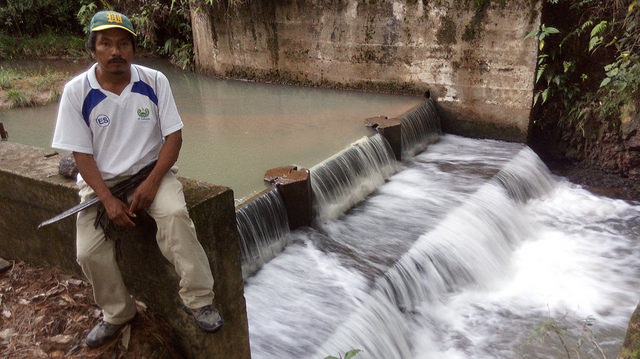 The community leader of Joya de Talchiga, Juan Benítez, stands at the edge of the dam that the villagers built to create the El Calambre mini-hydroelectric plant, which finally provided the 40 families of this mountain hamlet in eastern El Salvador with electricity. CREDIT: Edgardo Ayala/IPS