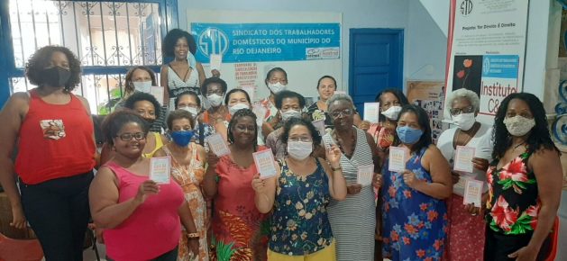 A group of domestic workers gather at their union headquarters in Rio de Janeiro for a class on the law that sets out the rights and obligations of domestic work in Brazil. Learning about the law helps these women defend their rights and combat the vulnerability many of them of them face in the solitude of their employers’ homes. CREDIT: Courtesy of STDRJ