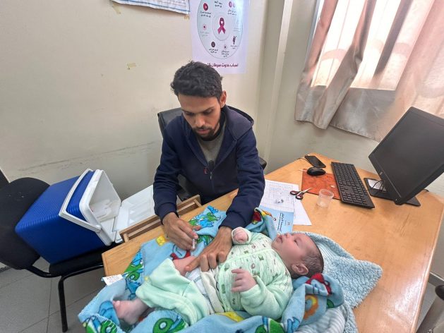 A health worker in Gaza continues with an inoculation campaign. The Safeguarding Health in Conflict Coalition has called for international action to end violence against or obstruction of health care in conflicts. Credit: UNWRA/Twitter