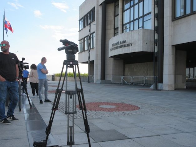 Camera crews wait outside the Slovak parliament building in Bratislava days after the attempted assassination of PM Robert Fico. Credit: Ed Holt/IPS