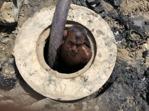 A sewer worker who is popularly known as Mithoo emerges from the sewer. Credit: Zofeen T. Ebrahim/IPS