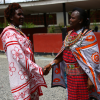 Naomy Kolian and Jane Kaliko share light moments after a tiring day of engaging the community at a public forum on the need to stop FGM. Credit: Robert Kibet/IPS