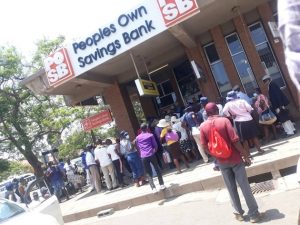 People queue outside a bank where they access diaspora remittances in Bulawayo. Credit: Ignatius Banda/IPS