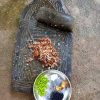 Green chillies, salt and ants on a stone mortar pestle depicts the process of how the chutney is prepared. Photo courtesy: Rajesh Padhial